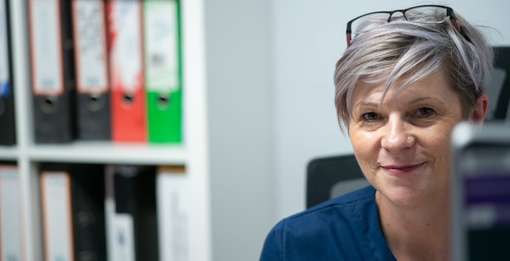 Nurse sat at her computer