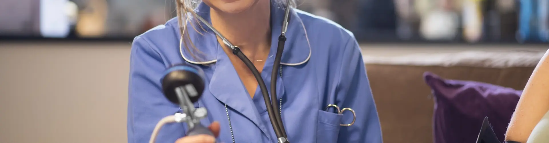 Nurse taking blood pressure reading