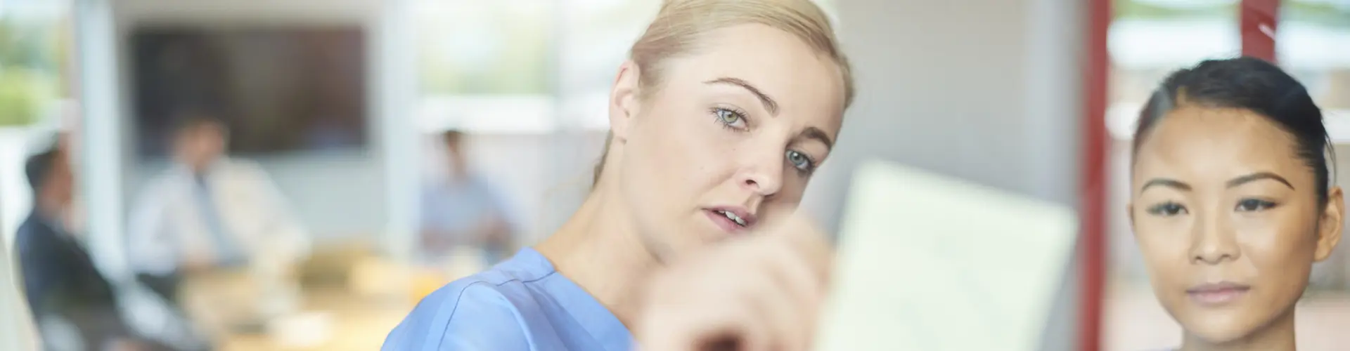 Two nurses reading a report