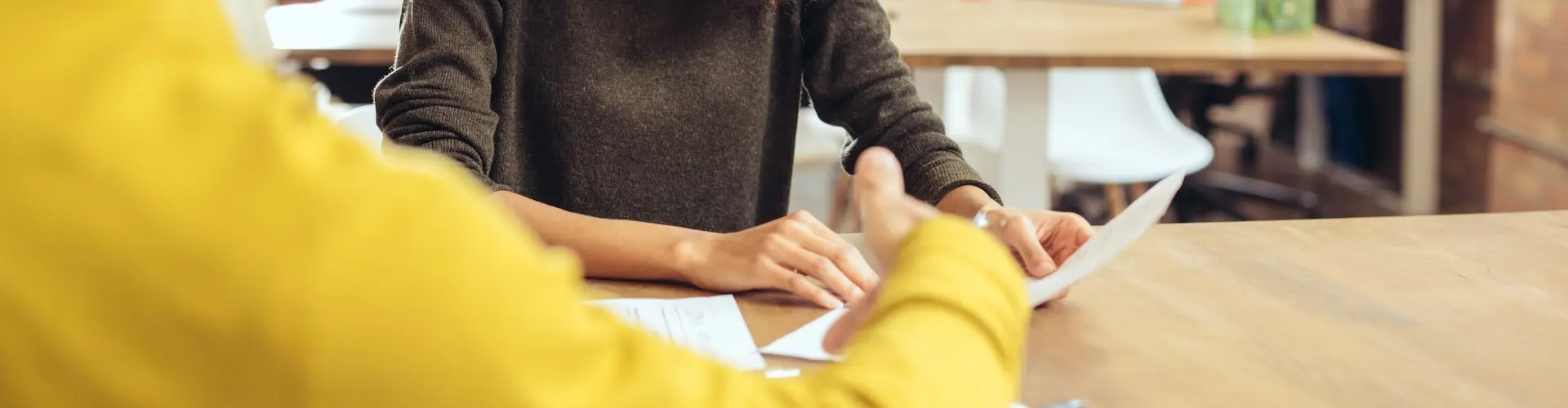 Two students in a classroom talking