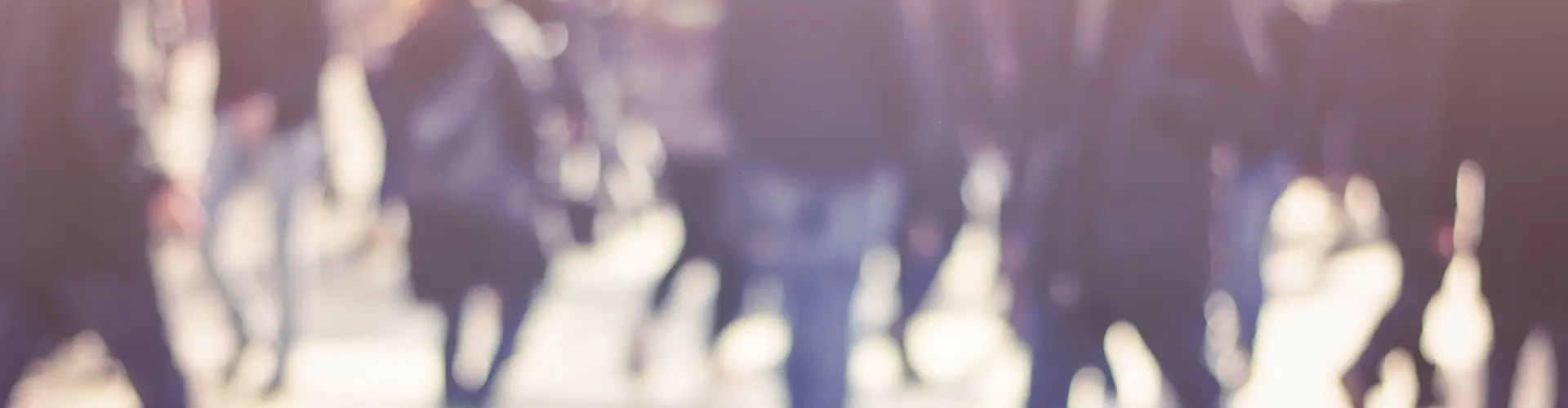 Soft focus photo of a group of people walking outdoors.