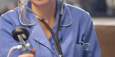 Nurse taking blood pressure reading