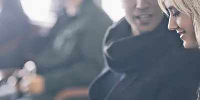 Two people talking in a waiting room