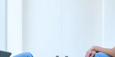 Two nurses sitting chatting in a hospital corridor