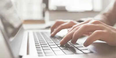 Person typing on a laptop