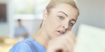 Two nurses reading a report