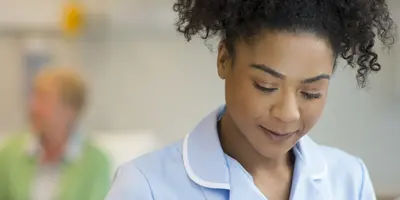 A nurse in consultation with a doctor on a ward