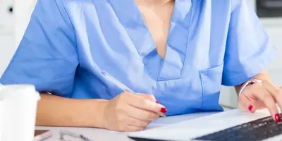 OH Nurse working on a laptop