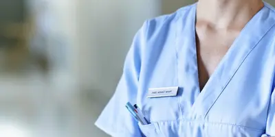 Photo of a nurse in blue scrubs