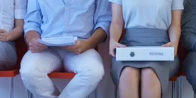 4 candidates sat in chairs waiting to be interviewed