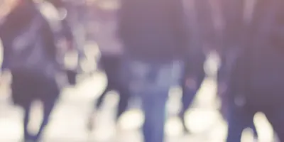 Soft focus photo of a group of people walking outdoors.